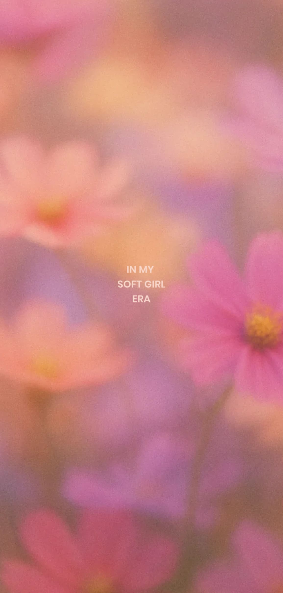 Pink and purple blurred flowers with text “IN MY SOFT GIRL ERA” in the center.