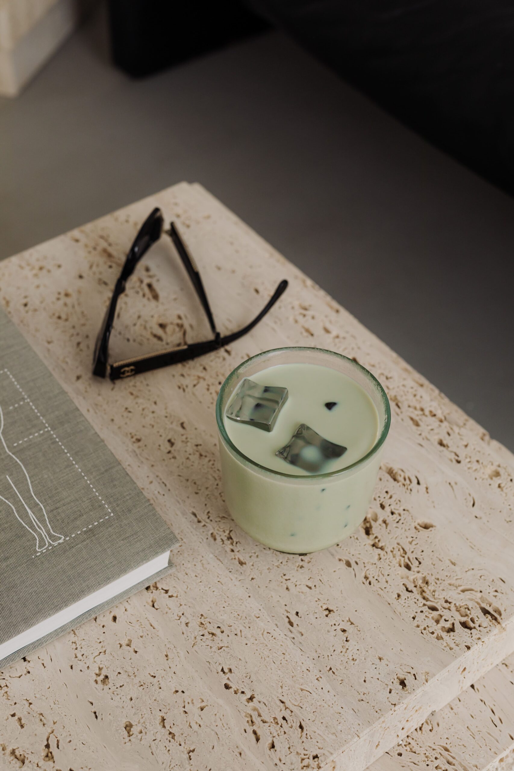 Calm workspace setup with matcha latte and wellness book—supporting holistic nutritionists building their business and attracting more clients.