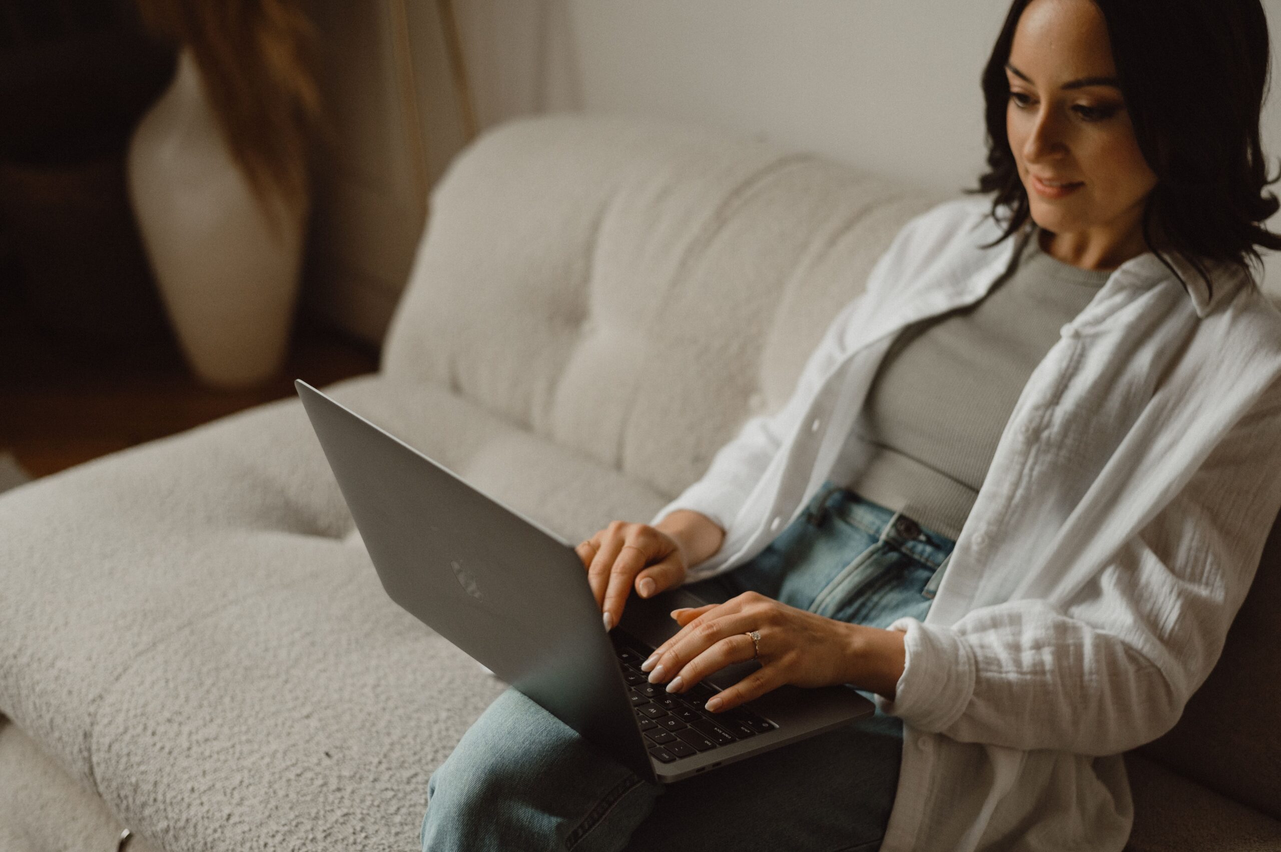 Wellness professional creating online course at laptop, planning to sell digital classes.